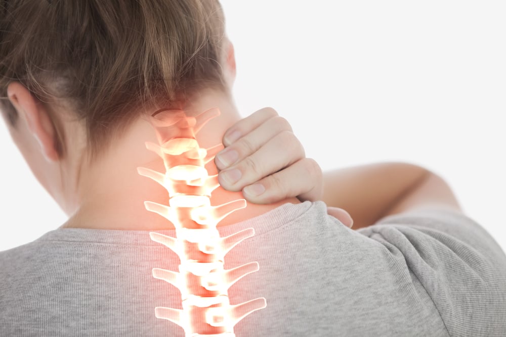 Digital composite of Highlighted spine of woman with neck pain